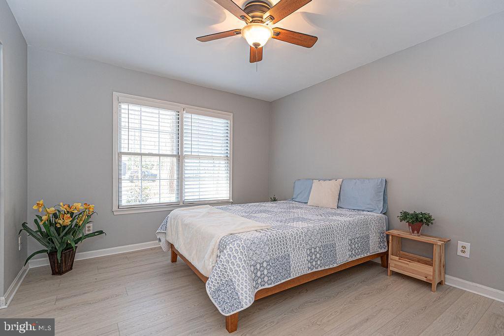 47 Falcon Bridge Road Ocean Pines, MD 21811 - Photo 17 of 78 a bedroom with a bed and a chandelier