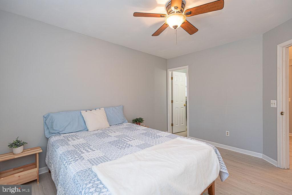 47 Falcon Bridge Road Ocean Pines, MD 21811 - Photo 18 of 78 a bedroom with a bed and a chandelier