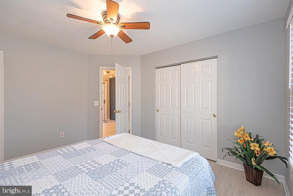 47 Falcon Bridge Road Ocean Pines, MD 21811 - Photo 19 of 78 a bedroom with a bed and a chandelier