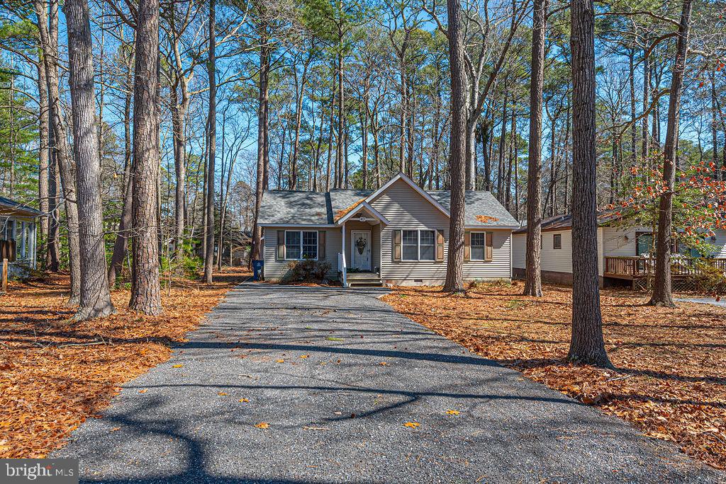 47 Falcon Bridge Road Ocean Pines, MD 21811 - Photo 2 of 78 a front view of a house with trees and stairs