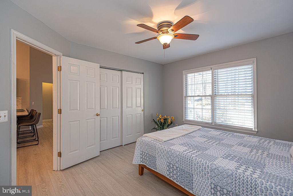 47 Falcon Bridge Road Ocean Pines, MD 21811 - Photo 24 of 78 a spacious bedroom with a bed and a chandelier