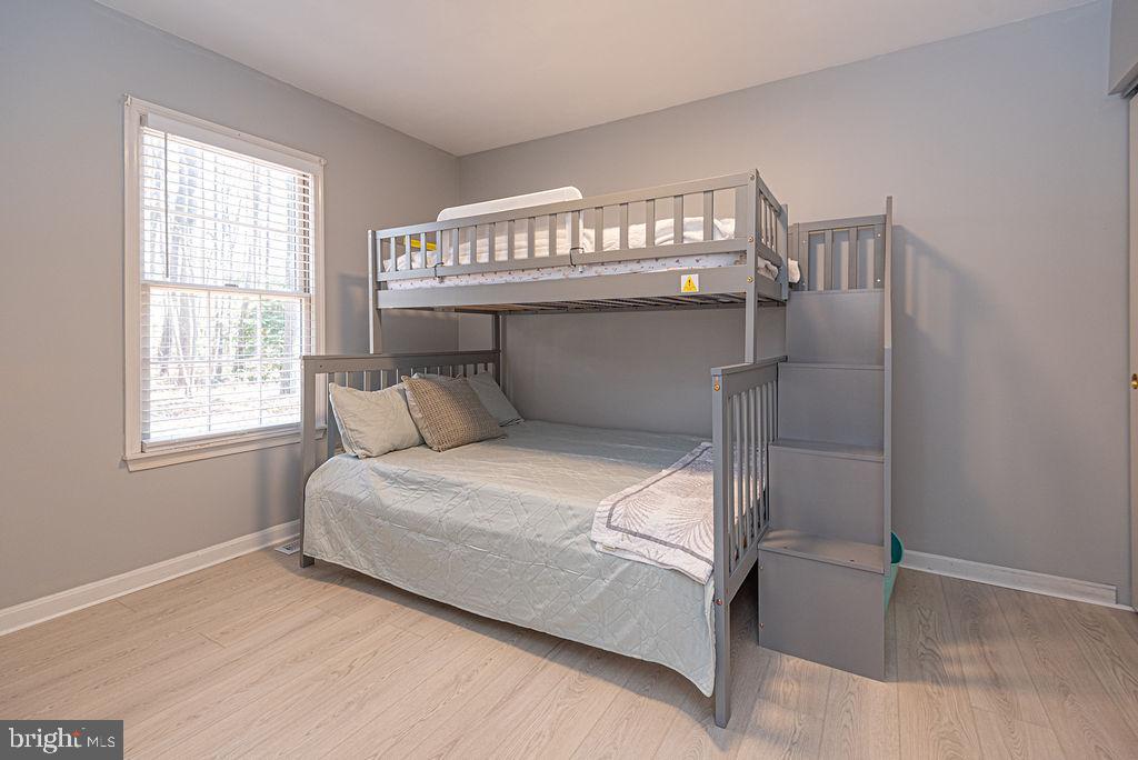 47 Falcon Bridge Road Ocean Pines, MD 21811 - Photo 26 of 78 a bedroom with a bed and windows