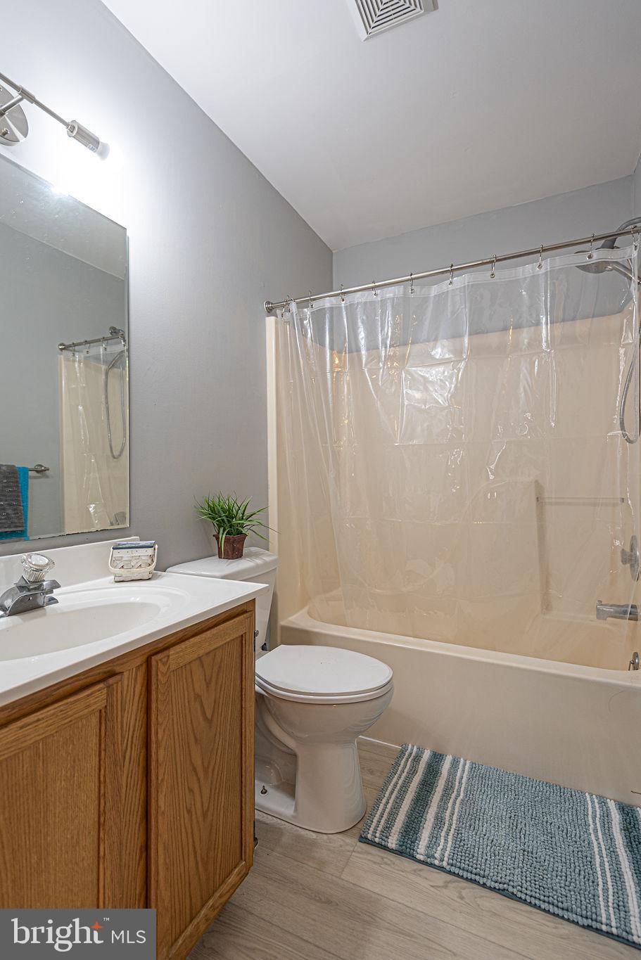47 Falcon Bridge Road Ocean Pines, MD 21811 - Photo 33 of 78 a bathroom with a sink a toilet a mirror a bathtub and shower