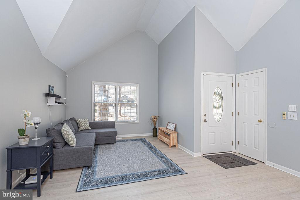 47 Falcon Bridge Road Ocean Pines, MD 21811 - Photo 5 of 78 a living room with furniture and wooden floor