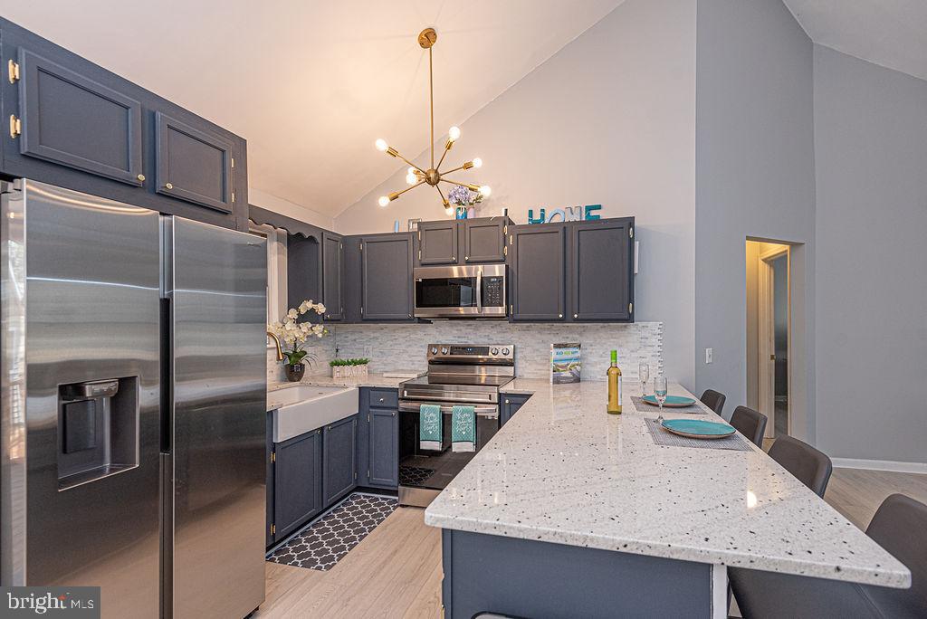 47 Falcon Bridge Road Ocean Pines, MD 21811 - Photo 9 of 78 a kitchen with stainless steel appliances granite countertop a sink a stove and a refrigerator