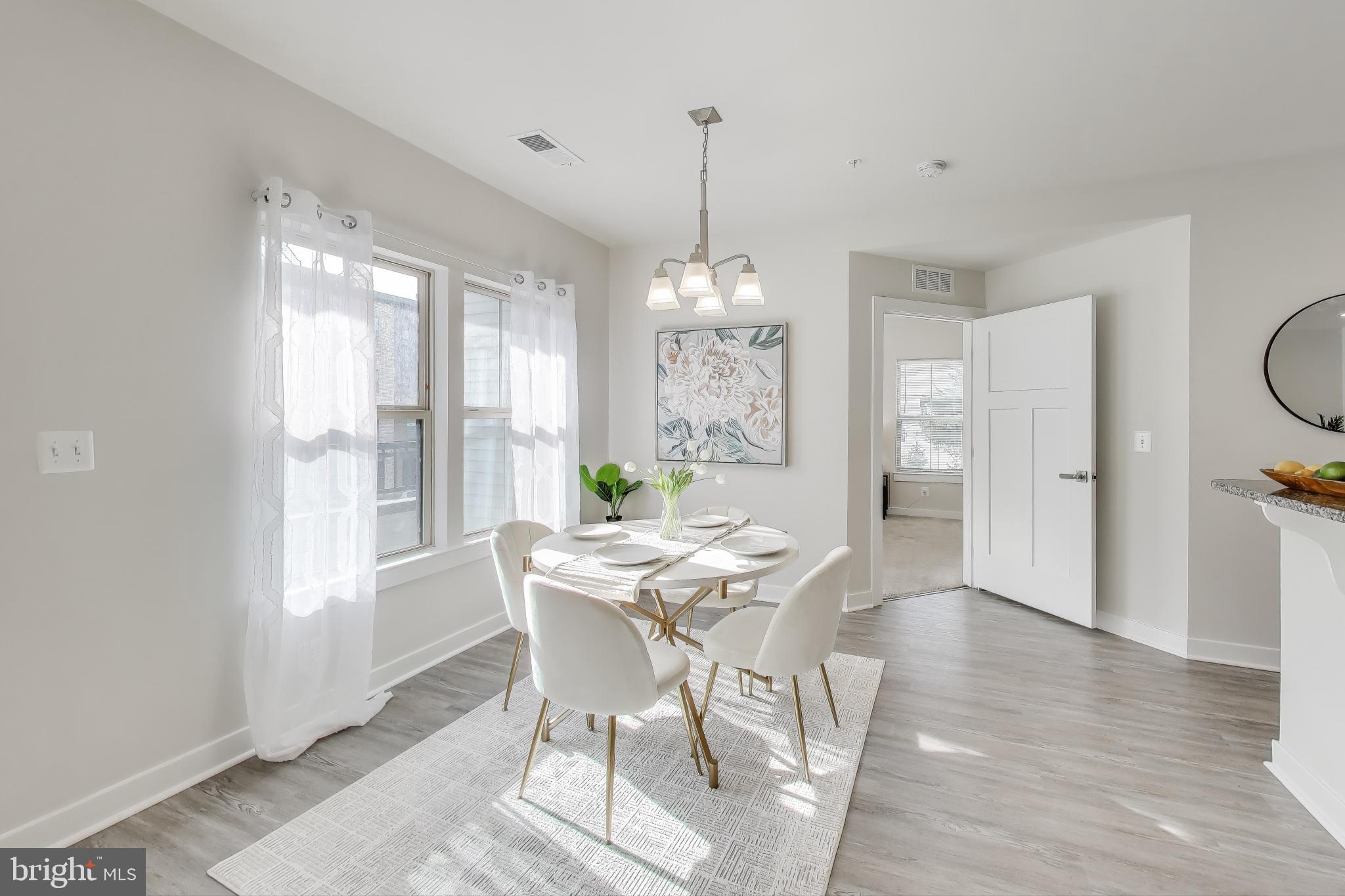 10020 Ruffian Way, Unit E Laurel, MD 20723 - Photo 9 of 30 a view of a dining room with furniture window and wooden floor