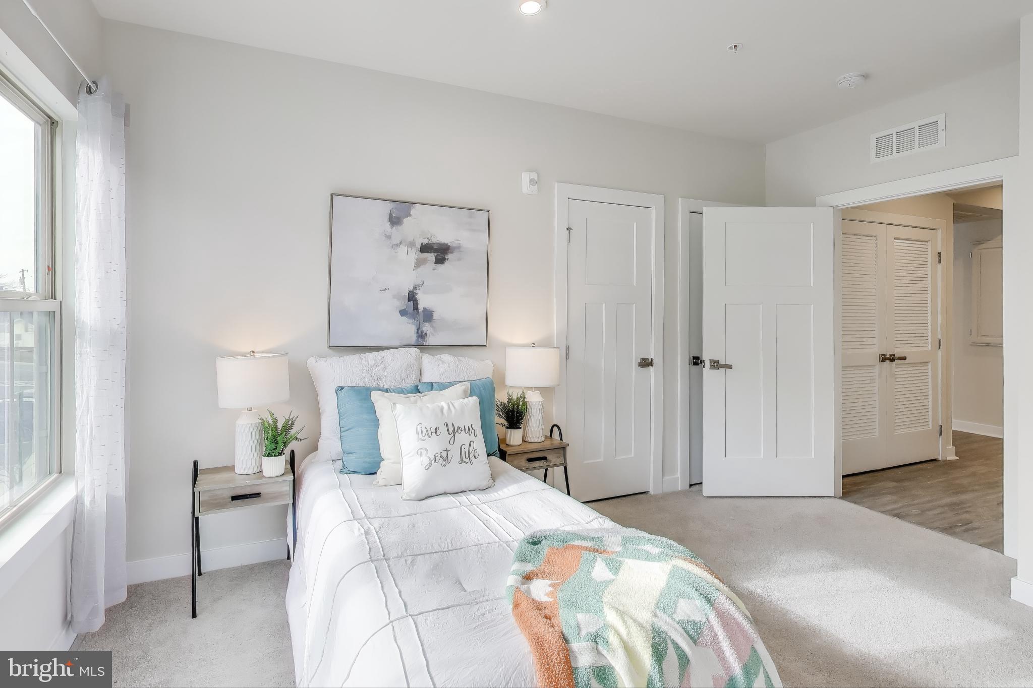 10020 Ruffian Way, Unit E Laurel, MD 20723 - Photo 18 of 30 a bedroom with a bed and a window