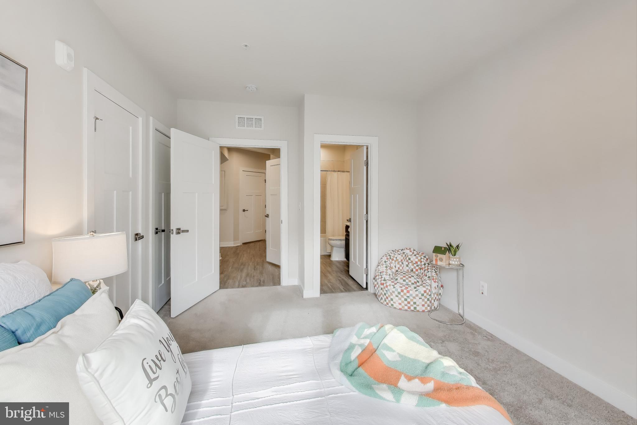 10020 Ruffian Way, Unit E Laurel, MD 20723 - Photo 19 of 30 a spacious bedroom with a bed and a couch