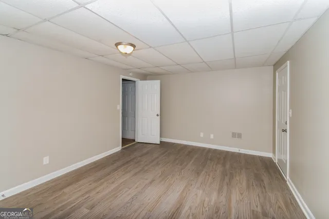a view of an empty room with wooden floor