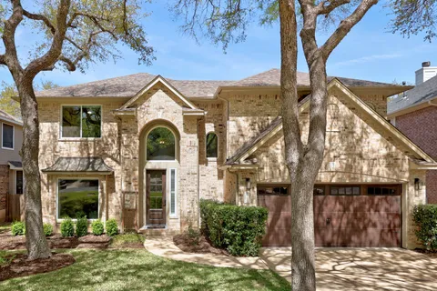 a front view of a house with yard and outdoor seating
