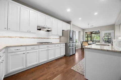 a kitchen with refrigerator and cabinets