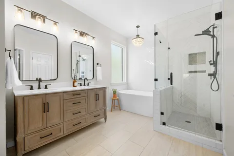 a bathroom with a double vanity sink mirror double and shower