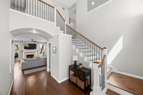 a view of entryway and hall with wooden floor