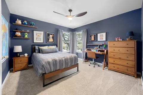 a spacious bedroom with a bed and a table in it