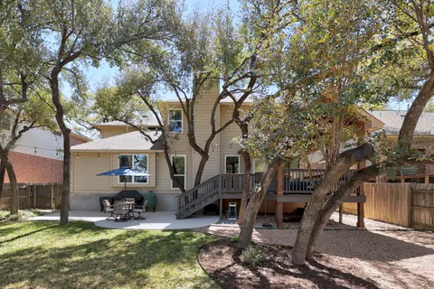 a view of a house with backyard porch and sitting area