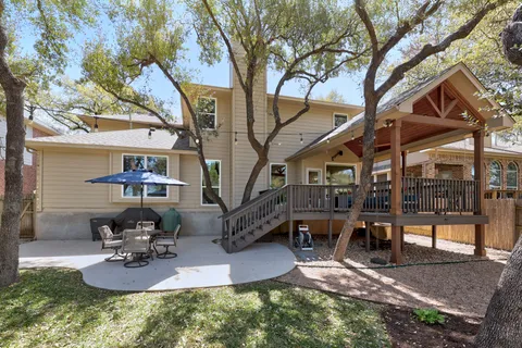 a backyard of a house with outdoor seating