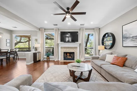 a living room with furniture a fireplace and a flat screen tv
