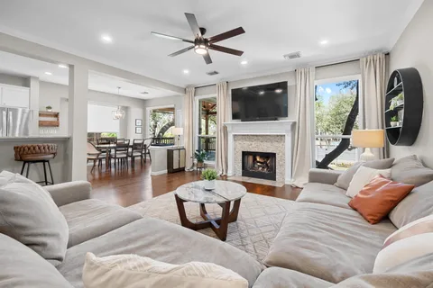 a living room with furniture a flat screen tv and a fireplace