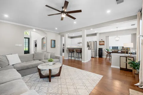 a living room with furniture and a view of kitchen