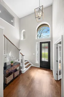 a view of an entryway with wooden floor
