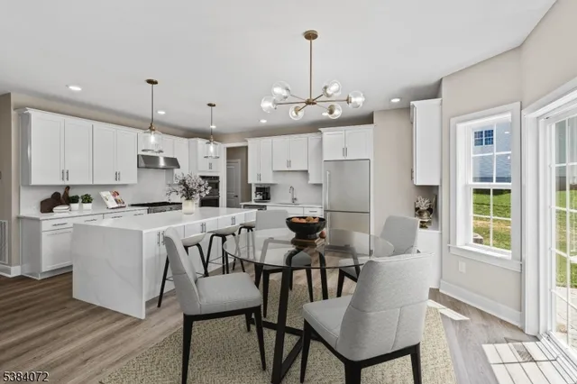 a view of kitchen with cabinets table and chairs