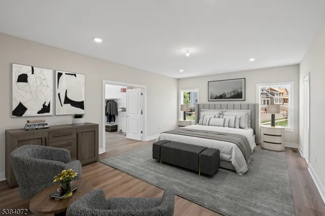 a spacious bedroom with a bed a couch and dresser