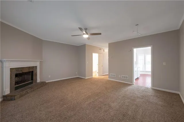 a view of an empty room with a fireplace
