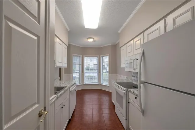 a spacious bathroom with double vanity and a large window