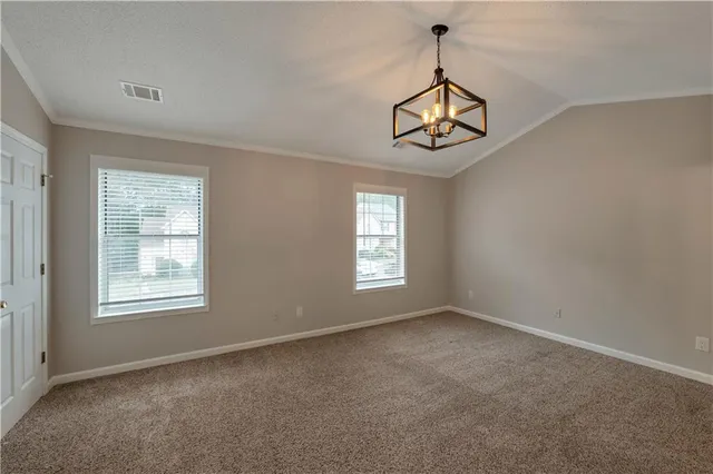 an empty room with windows and entrance