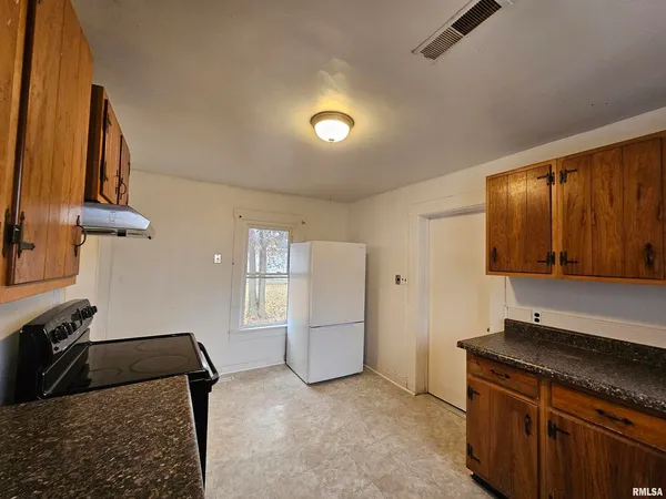 a view of a kitchen with furniture and a window