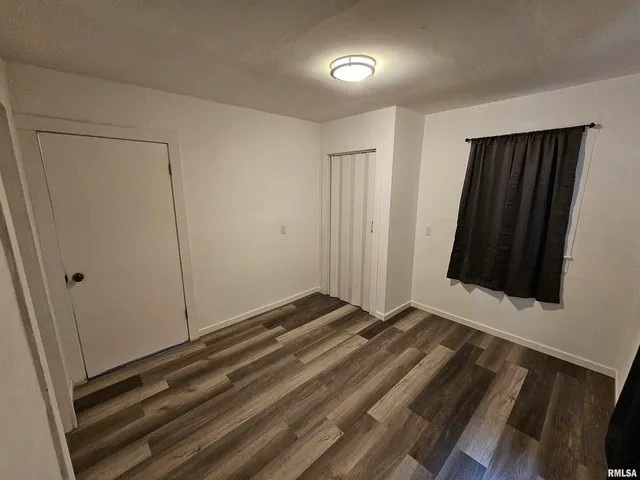 a view of a room with wooden floor