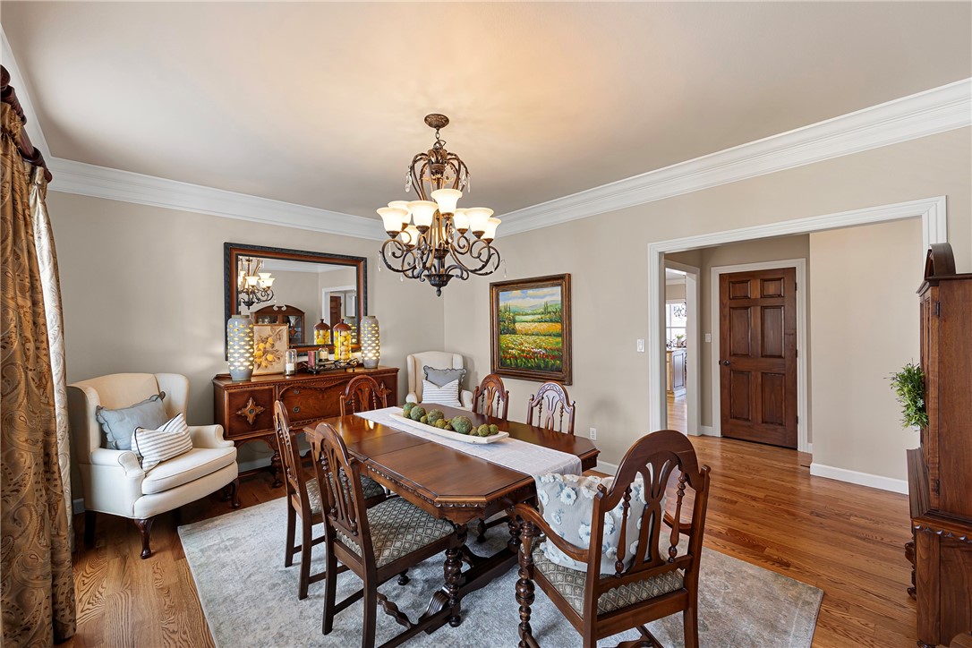 788 Cliff Road Russellville, AR 72802 - Photo 16 of 60 Dining room featuring wood finished floors, a chandelier, and ornamental molding