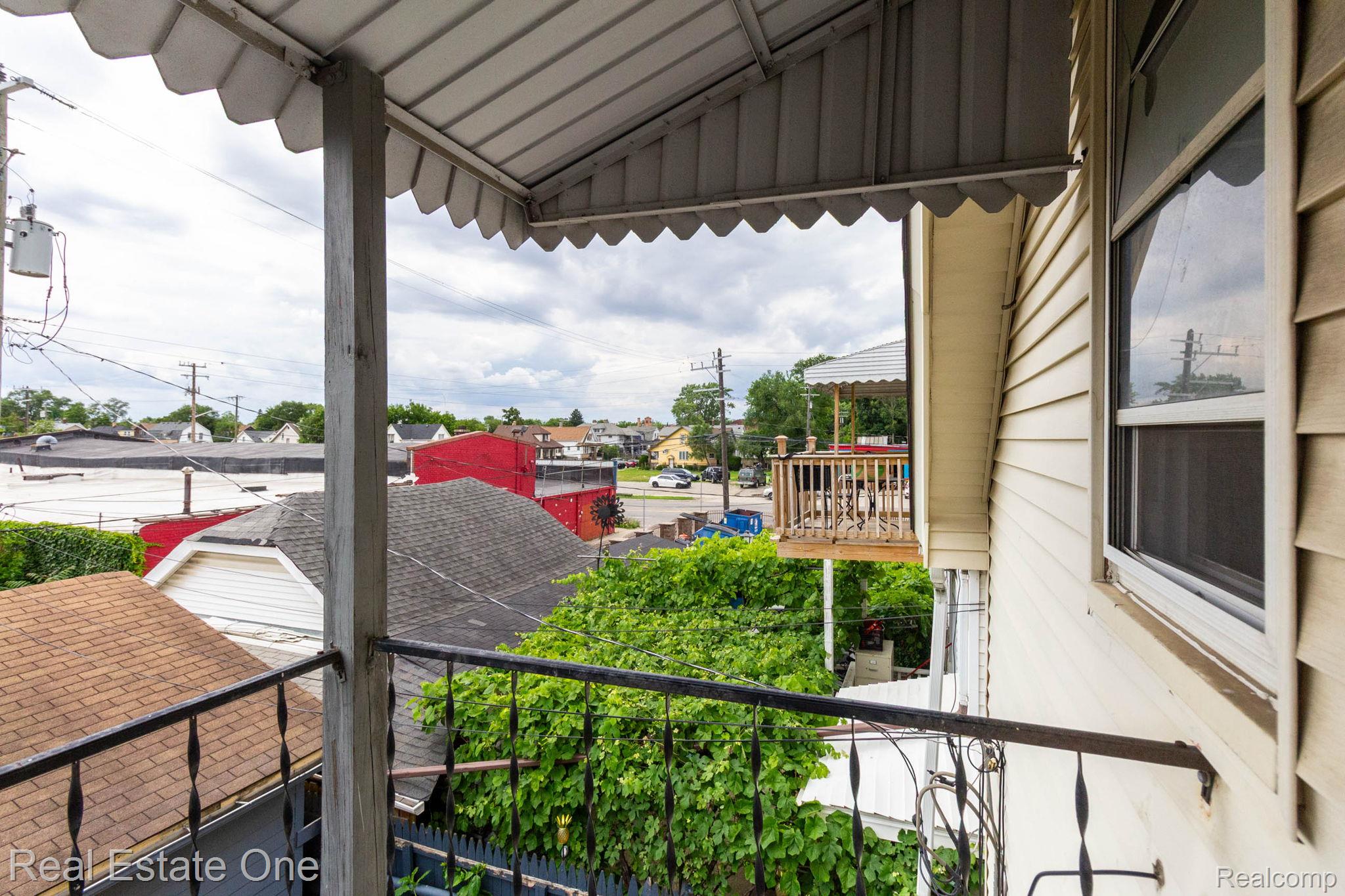 5485 Springwells Street Detroit, MI 48210 - Photo 37 of 47 Covered balcony with black wrought iron railing, offering a vantage point to the surrounding area