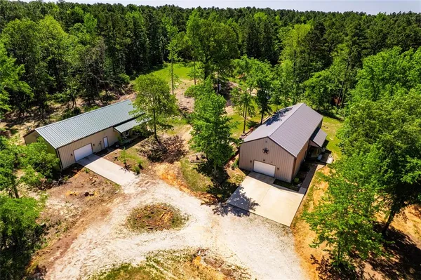 an aerial view of a house with a yard and lake view