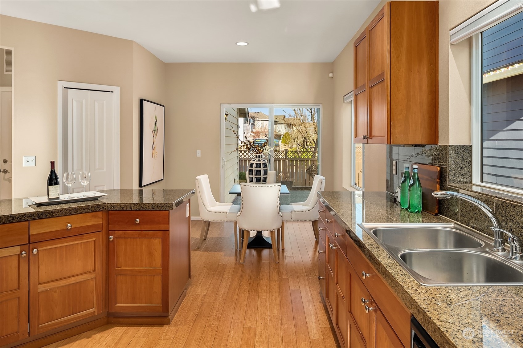 6608 West Crestview Loop Southeast Snoqualmie, WA 98065 - Photo 12 of 29 a kitchen with sink cabinets and wooden floor