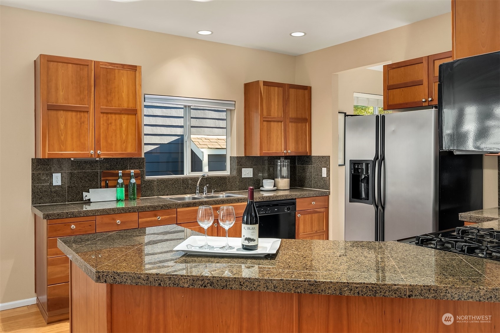 6608 West Crestview Loop Southeast Snoqualmie, WA 98065 - Photo 13 of 29 a kitchen with stainless steel appliances granite countertop a sink stove and refrigerator