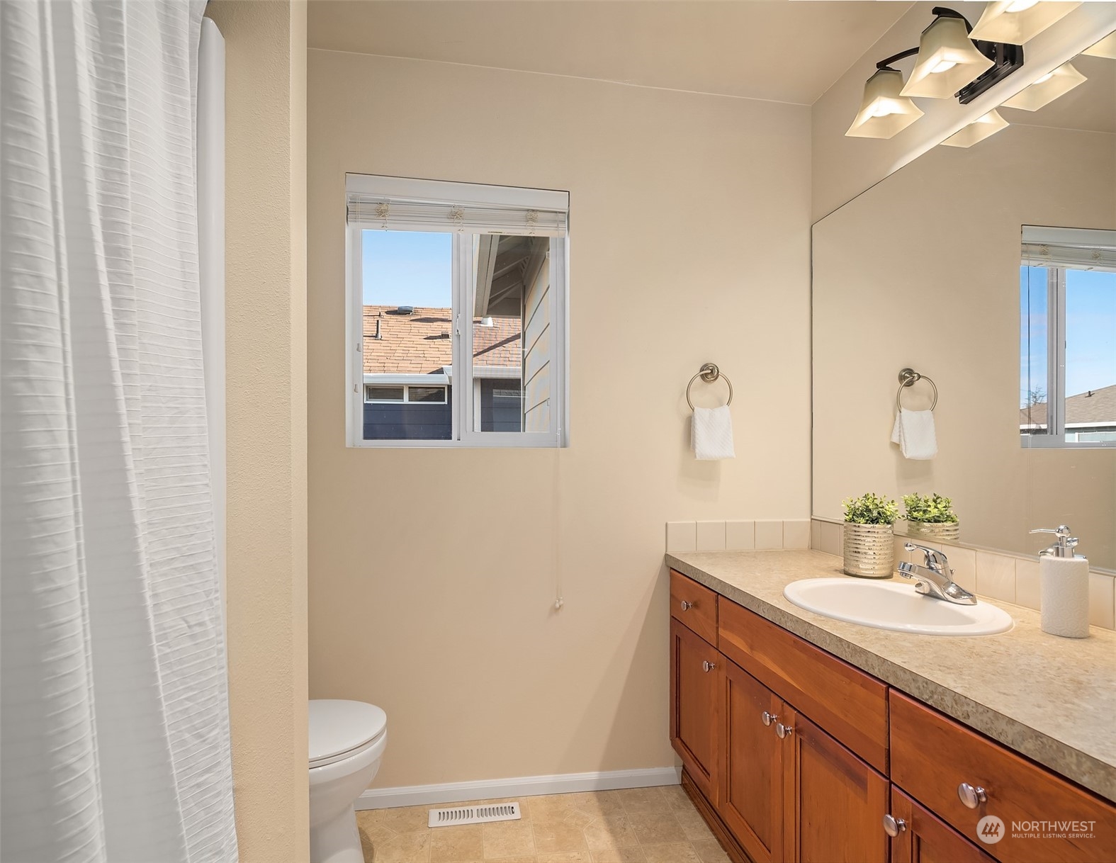 6608 West Crestview Loop Southeast Snoqualmie, WA 98065 - Photo 23 of 29 a bathroom with a sink a toilet and mirror
