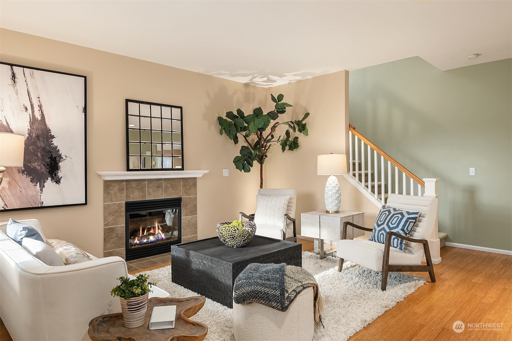 6608 West Crestview Loop Southeast Snoqualmie, WA 98065 - Photo 6 of 29 a living room with furniture a fireplace and a potted plant