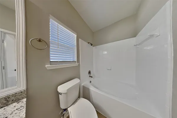 a bathroom with a toilet a sink and bathtub
