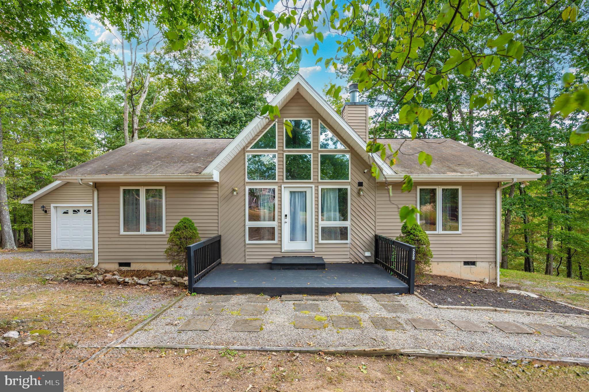 a front view of house with yard outdoor seating and barbeque oven