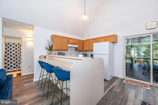 a kitchen with a refrigerator a stove top oven a sink and dishwasher