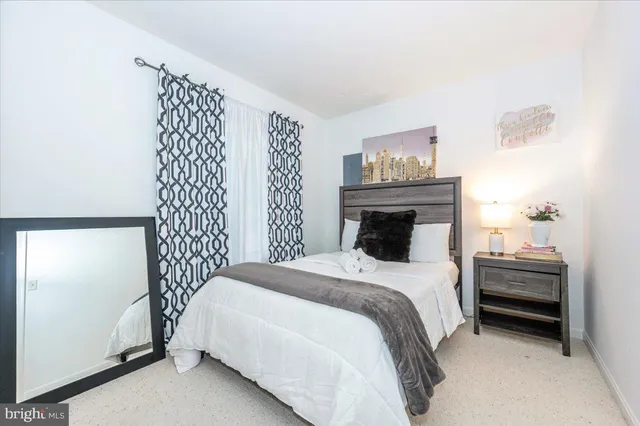 a bedroom with furniture and baby crib
