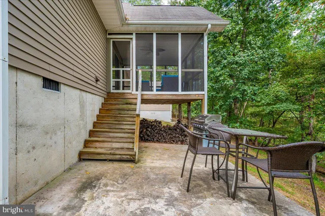 a view of a house with a yard and sitting area