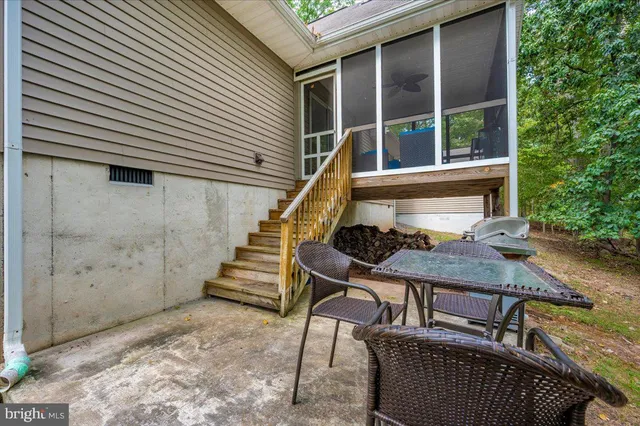 a view of house with a chairs and table in a patio