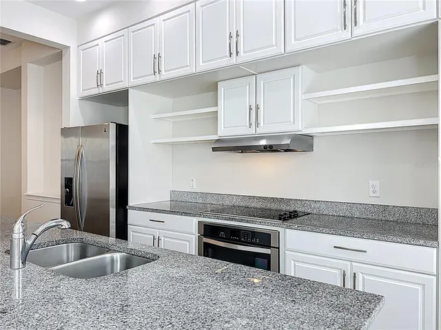 a bathroom with a granite countertop sink a toilet and a mirror