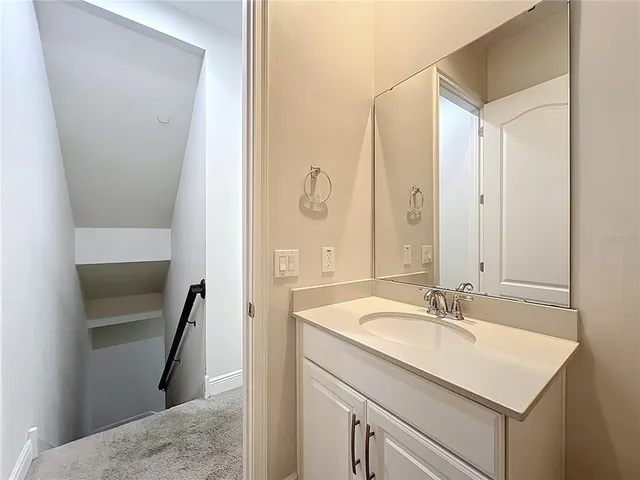 an empty room with closet and a chandelier fan