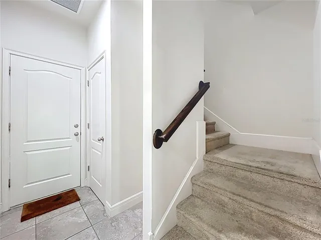 an empty room with fan and windows