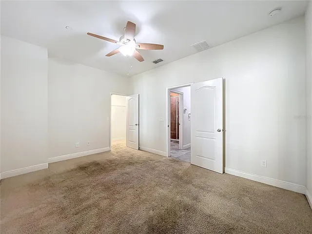 a bathroom with a granite countertop sink a toilet and shower