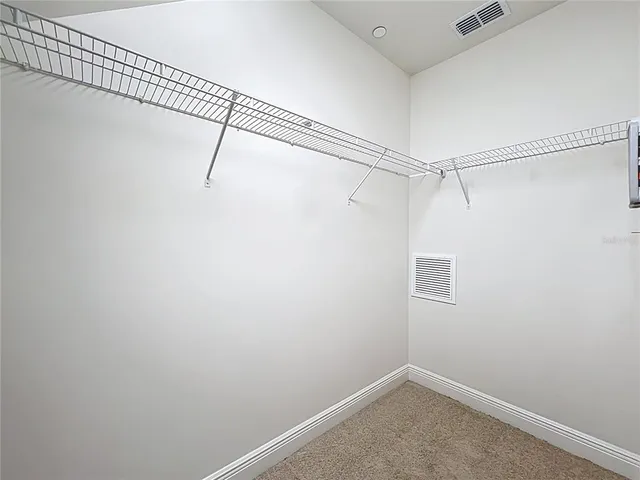 a bathroom with a granite countertop sink a large mirror and a bathtub