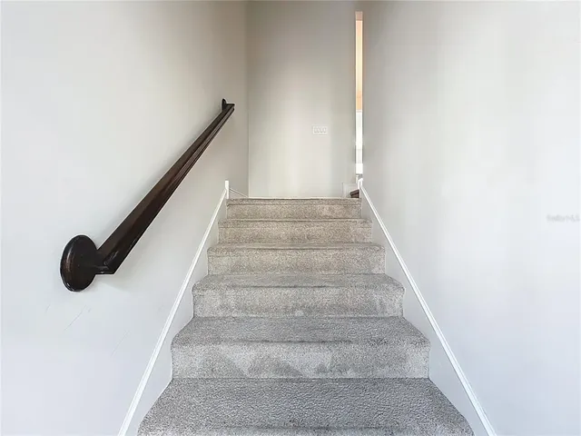 a view of an empty room with stairs